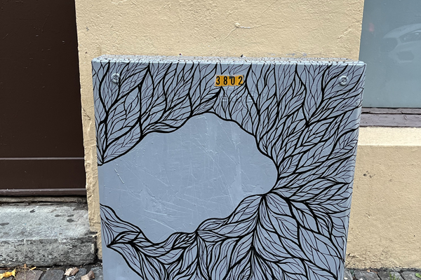 Ett målat elskåp på andra långgatan med grå bakgrund och svarta blad