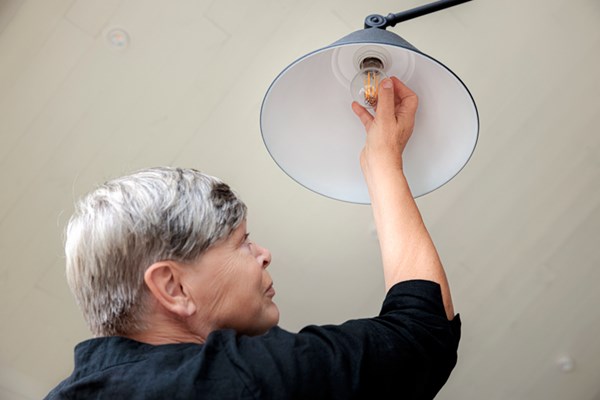 Person byter glödlampa